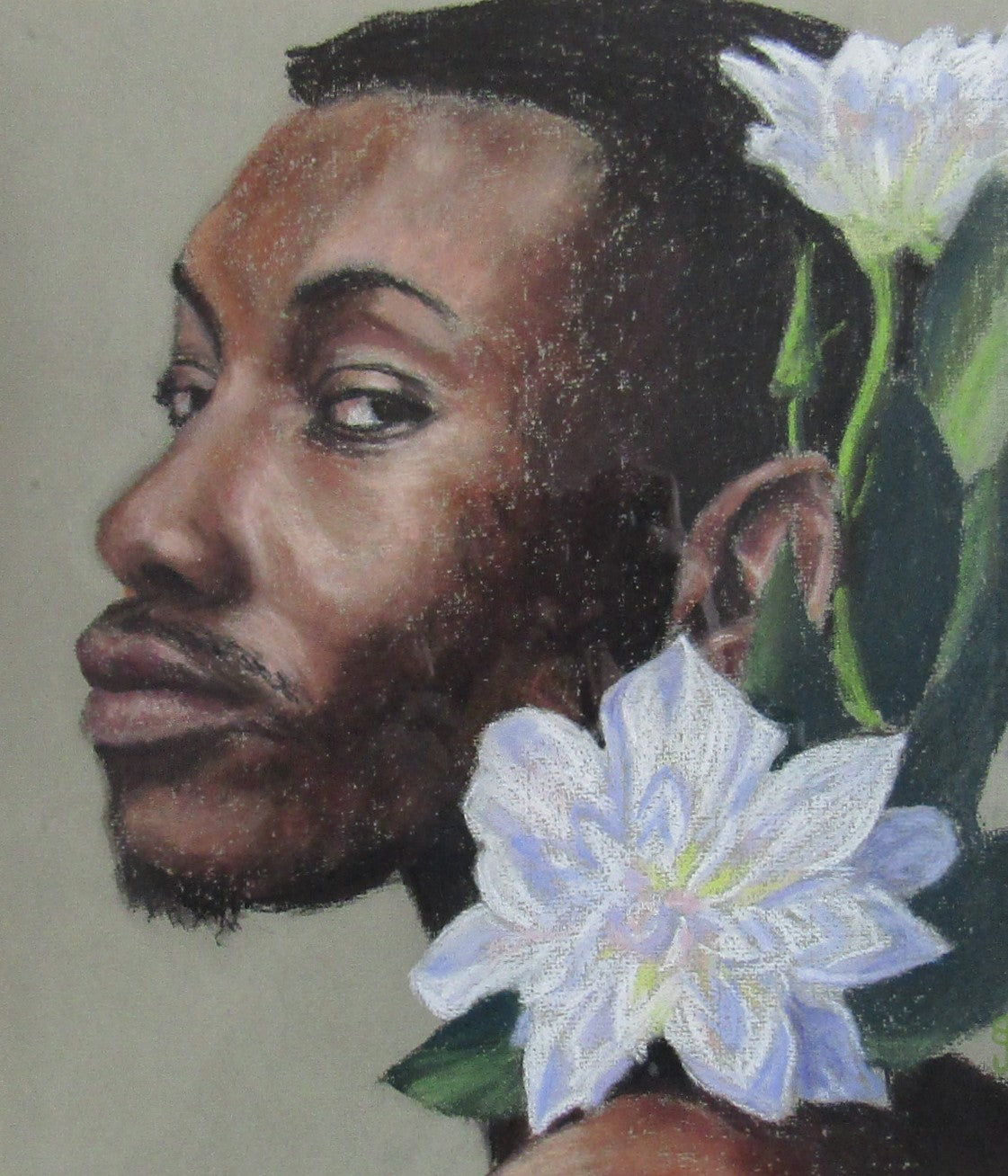 A pastel portrait of a bearded man of colour wearing decorative white flowers
